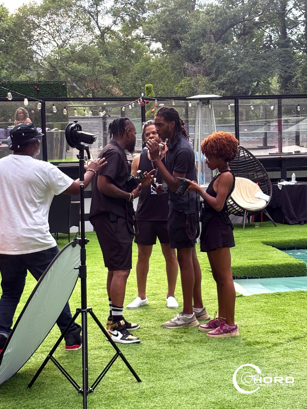 Ed Jones directing a group of models during an event shoot